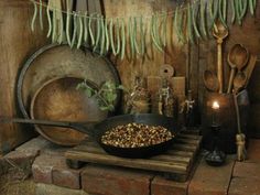 a rustic kitchen with an old frying pan and wooden utensils