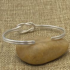 ❋ Handmade Sterling Silver Simple Dainty Knot Cuff Bracelet ❋ Size: Adjustable Women size M-L (Men size S) ❋The Length of the cuff (end to end from the outside) is about 6 3/4 inches ( / 173mm). ❋ Metal Purity: 95% Silver. (Purer than 925 Sterling Silver). To browse some more of our silver jewelry collection you can click on the following links: https://www.etsy.com/shop/SilverShapes Earrings: https://www.etsy.com/shop/SilverShapes?section_id=14809462&ref=shopsection_leftnav_1 Rings: https:/ Simple Adjustable Bangle For Everyday, Adjustable Simple Everyday Bangle, Handmade Adjustable Minimalist Cuff Bracelet, Adjustable Simple Cuff Bracelet As Gift, Handmade Minimalist Adjustable Cuff Bracelet, Minimalist Handmade Adjustable Cuff Bracelet, Simple Adjustable Bracelet Bangle, Simple Adjustable Bangle Bracelet, Simple Adjustable Cuff Bracelet For Everyday