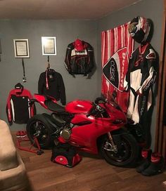 a red motorcycle is parked in the corner of a room