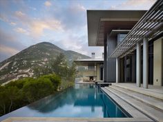 an outdoor swimming pool with steps leading up to it and the mountains in the background