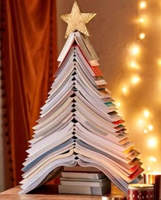 a christmas tree made out of books on a table