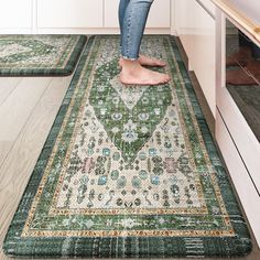 a woman standing on top of a rug in a kitchen