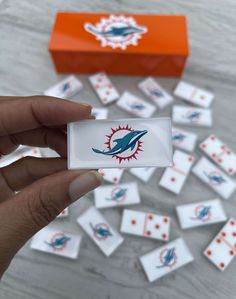 the miami dolphins logo is displayed on a card game box and it's surrounded by other cards