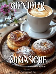 a plate topped with donuts on top of a table next to a cup of coffee