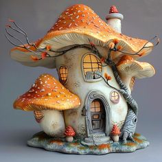 a ceramic mushroom house with trees and mushrooms on the roof