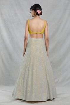 Beige lehenga featuring all-over sandwich sequin embellishments. Paired with a sleeveless yellow blouse adorned with cutdana jaal embroidery and a ruffled dupatta., Fit: Relaxed Lehenga Pattern, Yellow Blouse, Sequins Embroidery, Sweetheart Neck, Sequin, Sweetheart Neckline, Aza Fashion, Lehenga, Sandwiches