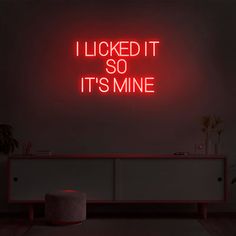 a red neon sign that says i looked it so it's mine on the wall