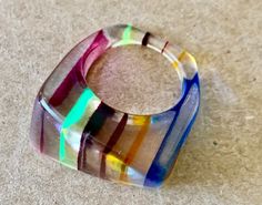 Women’s multicolor, acrylic ring. Good condition, size 6.5Detailed measurements:Inside Circumference - .75 inchesPendant Length - 1 inches 80's Clothes, Acrylic Ring, 80s Outfit, 70s Vintage, Color Free, Rainbow Colors, Cuff Bracelets, Swirl, Bangles