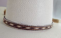 Cowboy hat band, genuine horsehair hat band, Five Strands wide ( 5/8 inch) BOLDLY done in a a natural brown-rich black and off-white Double horse hair tassels, Oh So Stetson perfect, **VERY Distinctive look **OUTSTANDING QUALITY ** STETSON perfect ** LUXURIOUS 100% genuine horsehair ** 5/8 inch wide. You will quickly discover that nothing compares to this extraordinary beauty: This horsehair hat band DEMANDS attention. This beauty is a 5 strands wide. Each strand is about 1/8 inch wide, separate White Fedora Panama Hat For Ranch, Classic White Hat Bands For Rodeo, Classic White Hat Band For Rodeo, White Southwestern Short Brim Hat, White Brimmed Hat Bands For Rodeo, White Southwestern Hat For Western-themed Events, White Southwestern Fedora Hat Bands, White Southwestern Hat For Country Events, White Adjustable Panama Hat For Western-themed Events