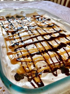 a dish filled with ice cream and caramel drizzle