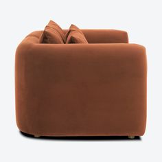 a brown couch sitting on top of a white floor