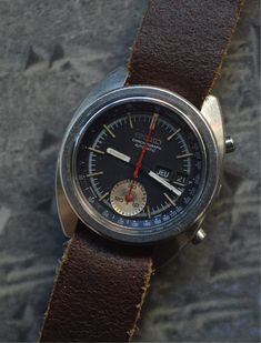 A legendary Seiko model, worn by Bruce Lee at the time that earned the watch its nickname.  This 1966 model is the first Chronograph in watchmaking history.  Everything is functional, with the chrono hand returning perfectly to zero.  Calibre 6139-6012 appreciated by connoisseurs and amateurs alike.  Brown leather NATO strap.  Case size excluding crown: 40mm x 43mm. Seiko Chronograph, Mens Wrist Watches, Gift Ideas Birthday, Seiko 5, Nato Strap, Vintage Watches For Men, Wrist Wear, Bruce Lee, Wristwatch Men