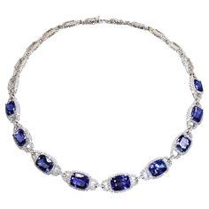 Indulge in the mesmerizing beauty of this exquisite 14 karat white gold necklace featuring a stunning cushion tanzanite pendant. Crafted with exceptional artistry, this necklace showcases the finest quality vivid AAA tanzanite weighing an impressive 35.63 carats. The vibrant purple hues of the tanzanite are perfectly complemented by the radiant sparkle of 4.51 carats of dazzling diamonds, adding an enchanting touch to this timeless piece. With its exceptional design and impeccable gemstone quality, this necklace is a true testament to elegance and sophistication. Discover the allure of rare gemstones at 1stDibs and elevate your jewelry collection to new heights of luxury. Luxury Tanzanite Exquisite Jewelry, Luxury Tanzanite Necklace For Women, Luxury Gold Tanzanite Necklace, Tanzanite Pendant, Tanzanite Necklace, White Gold Necklace, Mesmerizing Beauty, White Gold Necklaces, Vibrant Purple