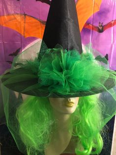 Inspired by the musical - this Wicked witch hat is black with emerald green tulle veil - tulle floral with center jewel. Fits up to 22.75 inches head circumference. Feathers shown in last photo can be added for additional charge. Witchy Brimmed Costume Hats For Parties, Adjustable Green Costume Hats And Headpieces, Green Halloween Hats For Costume Party, Adjustable Green Costume Hat For Halloween, Adjustable Green Costume Hats And Headpieces For Halloween, Adjustable Green Halloween Costume Hat, Green Halloween Costume Party Hat, Green Halloween Costume Hats, Green Top Hat For Church