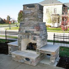 a stone fire place sitting on the side of a sidewalk