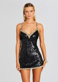 When you need to steal the spotlight and make a statement, our Ivanna Dress is your go-to choice. The mini length, sequin feather embellishments, and open back make this dress an irresistible choice for those who want to stand out from the crowd. Shown here in Black/Gold. HANDMADE 100% Nylon Made in India Model is 5'10" wearing size XS Style No. HL24-7983 Nye Dress, Hoco Dress, Theme Dress, Eve Dresses, Steal The Spotlight, New Years Dress