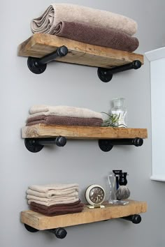 two wooden shelves holding towels and other items