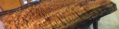 a close up of a piece of wood on a table in a room with wooden floors