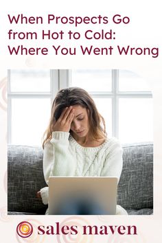 a woman sitting on top of a couch holding her head in front of a laptop