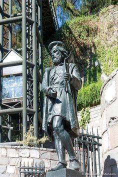 a statue of a man standing next to a building