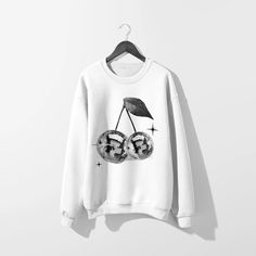 Get groovy in our Disco Cherries White Sweatshirt. Featuring sparkly Y2K vibes, this trendy sweatshirt will elevate your style game. Perfect for adding a touch of whimsy to your everyday look. (Disco ball not included!). This sweatshirt features a bound ribbed neckband, ribbed sleeve cuffs and hemband, and raglan sleev Trendy Fall Sweatshirt With Screen Print, Trendy Winter Graphic Sweatshirt, Trendy Graphic Print Sweatshirt For Fall, Trendy Fall Graphic Sweatshirt, Trendy Fall Sweater With Screen Print, Trendy Cotton Sweatshirt With Graphic Design, Trendy Streetwear Sweater With Screen Print, Trendy Sweater With Screen Print For Streetwear, Trendy Crew Neck Sweater With Screen Print