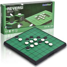 a green board game with white and black pieces on it's side, in front of a box