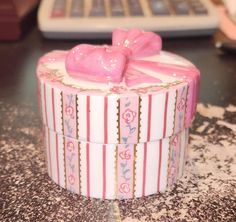 a pink heart shaped box sitting on top of a table