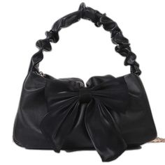 a black purse with a large bow on it