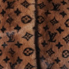 an animal fur coat with the letters louis vuitton on it's side