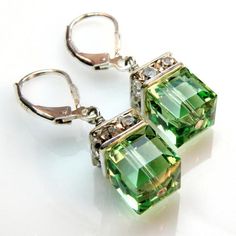 Short drop peridot green Swarovski crystal earrings are combined with sparkly rhinestones. Accented with a clear crystal on top. Handmade with sterling silver wire and sterling silver leverback earring closures. Green Swarovski crystal cubes mimic the gemstone color of peridot - the birth stone for Dangle Earrings Wedding, Peridot Crystal, Swarovski Crystal Earrings, Earrings Green, Green Crystal, Green Earrings, Earrings Wedding, Drop Earring, Bridesmaid Earrings