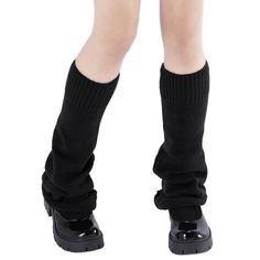 the legs and ankles of a child wearing black shoes