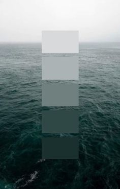 the ocean is very dark and green with some white squares on it's side