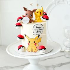 a pokemon themed birthday cake with pikachu and poke - poo figures on top