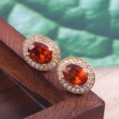 This Sterling Silver Jewelry set features an Elegant Art With Natural Hessonite Gemstone. The cavity is made from genuine solid 925/92.5 Sterling silver with 18k Gold Plating and stamped as S925. This Jewelry is Lead free and Rhodium plated to prevent scratches and tarnish. ITEM DESCRIPTION Item Code: JACBS2/45 Metal: 18k Gold over 925/92.5 Sterling Silver Gemstone: Genuine Natural Hessonite Gemstone Shape: Oval Gemstone Size: 6 X 8 MM Ring Dimension:- Length: 12 MM Width: 11 MM Weight: 3.93 gm Yellow Gold Topaz Earrings, Round Shape, Gold Round Gemstones For Anniversary, Yellow Gold Gemstone Round Earrings, Round Gold Gemstones Fine Jewelry, Gold Gemstone Jewelry For Anniversary, Round Gemstone Accent Earrings For Anniversary, Classic Round Earrings With Gemstone Accents, Oval Gold Gemstones With Accents, Gold Round Cut Gemstones For Wedding