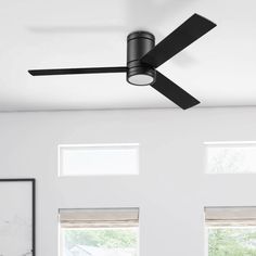 a black ceiling fan in a white room