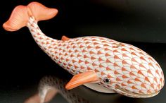 an orange and white fish figurine sitting on top of a black countertop