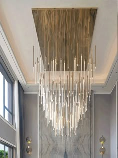 a large chandelier hanging from the ceiling in a room with marble walls and flooring