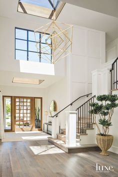 an open floor plan with wood floors and skylights above the stairs, is shown