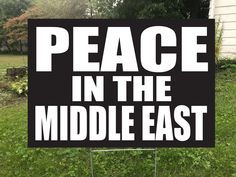 a black and white sign that says peace in the middle east on it's side