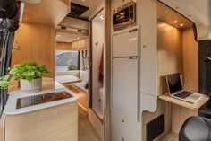 the interior of an rv with a laptop on the counter