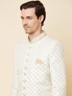 This Royal White Embroidered sherwani will instantly give an elegant look. Made from polyester cotton fabric, this 3 piece sherwani set features a white royal sherwani, front buttons fastening, designer cuff buttons, pocket square, and a mandarin collar. This white base sherwani has beautiful subtle gold Jaal thread-sequin embroidery work all over. It is paired with white churidar pants and matching dupatta. An ideal outfit for traditional & special events.

Size Chart For Men





	
	
					Men' White Bandhgala For Eid Festivities, White Bandhgala For Diwali, White Long Sleeve Sets For Reception, White Nehru Jacket With Naqshi For Diwali, White Chikankari Embroidery Bandhgala For Eid, White Bandhgala With Chikankari Embroidery For Eid, White Fitted Bandhgala With Resham Embroidery, White Long Sleeve Kurta For Reception, Formal Off White Bandhgala For Eid