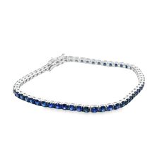 18 Karat white gold tennis bracelet with 6.14tw of blue sapphires. Length 7".