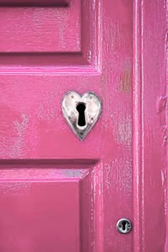 a pink door with a heart shaped keyhole