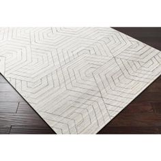 a white rug on top of a wooden floor