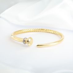 Slip into effortless elegance with our Gold Diamond Wrap Bangle—a perfect harmony of comfort and sophistication. Thoughtfully crafted with a hinged design for an impeccable fit, this timeless piece graces your wrist with ease while showcasing the brilliance of carefully set diamonds. The classic utilitarian-inspired design is elevated with a touch of sparkle, creating a piece that feels as good as it looks. A forever accessory, this bangle is destined to remain a cherished part of your collectio Classic Cuff Bracelet With Diamond Accents, Classic Cuff Bracelet With Brilliant Cut For Anniversary, Classic Single Cut Diamond Cuff Bangle Bracelet, Classic Single Cut Diamond Cuff Bangle, Elegant 14k Gold Bangle With Single Diamond, Timeless Diamond Bangle Bracelet With Accents, Classic Round Cuff Bracelet With Diamond Accents, Timeless Single Diamond Bangle For Anniversary, Timeless Anniversary Bangle With Single Diamond