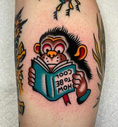 a monkey is reading a book on the thigh