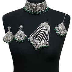 Handcrafted bottle green silver mirror Indian sheesha wedding / bridal jewellery set. Set includes- Earrings  Choker necklace Jhumar Tikka  Our choker is adjustable with a dori at the back giving you a comfortable fit. It comes with simple elegant mirror earrings with pearl detail, tikka and jhumar with hooks.  The glimmer of the mirrors with elegant pearl detail make this jewelry set a truly head turning piece, a must have for every jewellery box.  Our ethnic jewellery set harmoniously blends t Festive Silver Meenakari Lehenga, Silver Chandbali Lehenga With Meenakari, Festive Silver Lehenga With Meenakari, Festive Silver Lehenga With Meenakari Detailing, Silver Lehenga With Meenakari, Bollywood Style Silver Lehenga With Meenakari, Festive Silver Kundan Bridal Sets, Silver Bridal Sets For Festivals, Silver Kundan Lehenga For Wedding