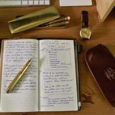 an open notebook sitting on top of a wooden desk