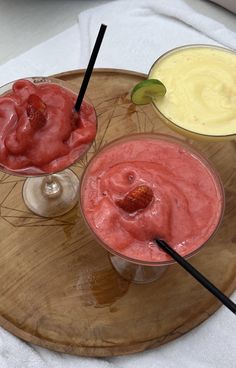 three different types of smoothies on a wooden tray