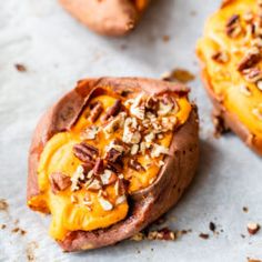 baked sweet potatoes topped with nuts and cheese